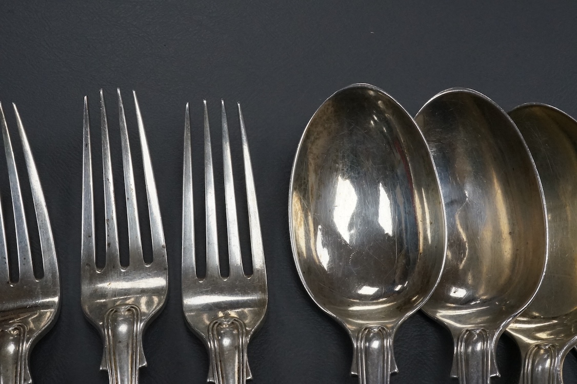 A set of six Edwardian silver fiddle and thread pattern table spoons, overstruck maker's marks, possibly Goldsmiths & Silversmiths Co Ltd, 21.6cm, and three matching table forks, London, 1901, 27.9oz.